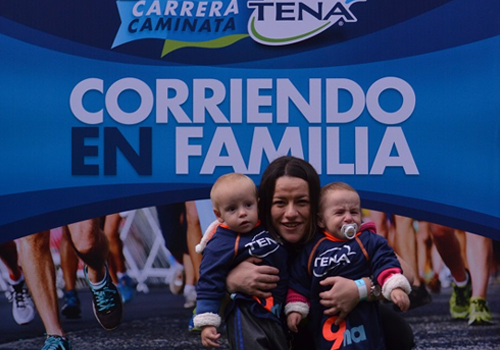 A woman poses with two small children A woman poses with two small children